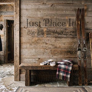 May include: Rustic wooden bench with a plaid scarf, knitted mittens, and vintage skis. The scene is set against a weathered wood wall with the text "Just Place It Blank Wall Mockups". A coat rack and window are visible.