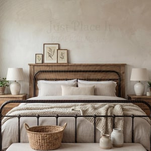 May include: A bedroom scene featuring a bed with a wooden headboard and a black metal frame. The bed is made with neutral-toned bedding and a woven throw. Two bedside tables with lamps and plants flank the bed. A woven basket and decorative vases are at the foot of the bed.
