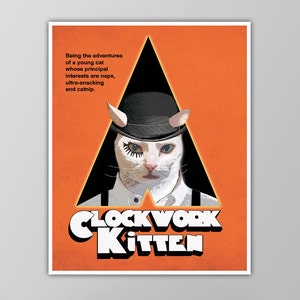 May include: A poster with an orange background and a black triangle. The triangle has a white cat with a black bowler hat and a white eye patch. The text "CLOCK WORK KITTEN" is in white letters on a black background.