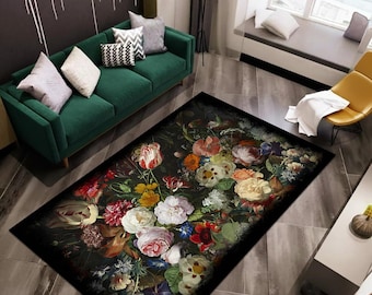 May include: A rectangular rug with a dark background and a colourful floral pattern. The rug displays a variety of flowers in shades of red, pink, yellow, and white. The rug is placed on a tiled floor in a living room setting.