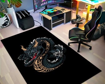 May include: Black rectangular rug featuring a detailed illustration of a dragon. The dragon is primarily black with tan and gold accents, and a red mouth. The rug is placed in a gaming room setting with a desk, chair, and computer monitors.