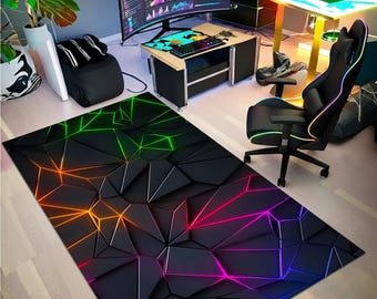 May include: A rectangular black rug with a geometric design. The rug features a 3D effect with raised triangular shapes and vibrant neon lines in green, orange, and pink. The rug is placed on a light-colored wooden floor.