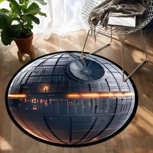 May include: A round rug featuring a detailed depiction of the Death Star from Star Wars. The rug is primarily dark gray with a black border and a prominent circular structure on top. Orange and yellow lights are reflected on the surface.