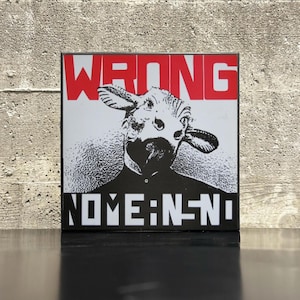 May include: Square art print featuring a black and white illustration of a person wearing a cow mask. The word "WRONG" is printed in red at the top, and "NOME:N-NI" is printed in white at the bottom.