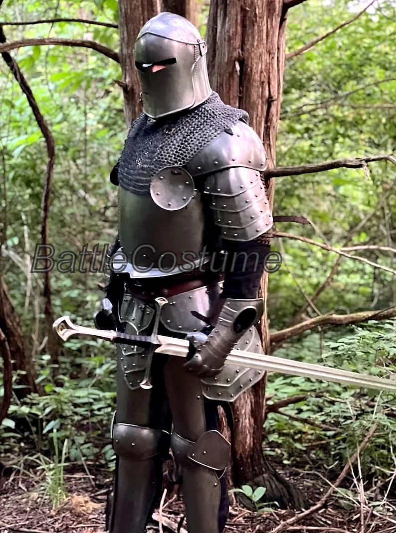 May include: A full suit of medieval armor, including a helmet, chainmail, and plate armor, is displayed. The armor is a dark metallic color and includes a sword. The image is set in a natural outdoor environment.