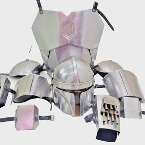 May include: A complete set of silver-colored armor, including a helmet, chest plate, shoulder pads, and gauntlets. The armor is made of metal and features various straps and attachments. The helmet has a distinctive T-shaped visor. The set is designed for cosplay or display.