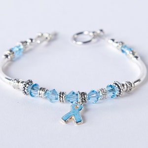 Light Blue Awareness Bracelet. Swarovski Crystal Charm. Prostate Cancer, Thyroid Disease, Graves, Addison&#39;s, Cushing, Edward&#39;s. Beaded.