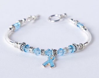 Light Blue Awareness Bracelet. Swarovski Crystal Charm. Prostate Cancer, Thyroid Disease, Graves, Addison's, Cushing, Edward's. Beaded.