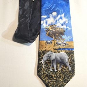 May include: A necktie featuring a blue sky and savanna scene with elephants. The tie's design includes a tree, clouds, and a herd of elephants. The tie's knot is black.