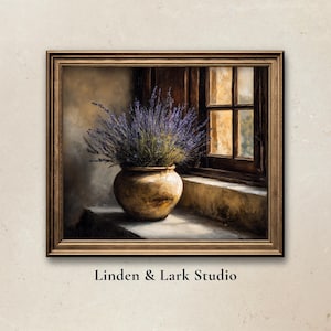 May include: A framed painting depicts a still life of a lavender bouquet in a rustic pot, set on a windowsill next to a wooden window. The artwork has a warm, vintage aesthetic, with soft lighting and muted colors. The text "Linden & Lark Studio" is at the bottom.