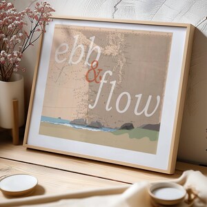 May include: A framed wall art print featuring a vintage-style nautical map background in shades of beige and brown. The text "ebb & flow" is overlaid in white and orange script. The bottom of the print depicts a stylized shoreline with blue water.