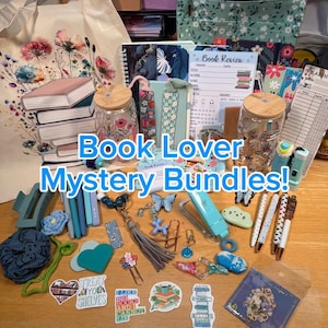 May include: A collection of book-themed items, including a tote bag, notebooks, bookmarks, stickers, pens, and glass jars. The text "Book Lover Mystery Bundles!" is displayed prominently. Various colors and patterns are visible.