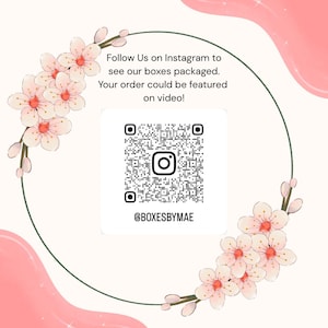 May include: A square graphic with a QR code and Instagram handle @BOXESBYMAE, surrounded by a floral design. Text reads "Follow Us on Instagram to see our boxes packaged. Your order could be featured on video!"