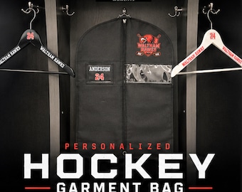 May include: Black hockey garment bag with the text "PERSONALIZED HOCKEY GARMENT BAG". Includes a clear window and a zipper. Two hangers with the text "WALTHAM HAWKS" and the number "24" are on either side of the bag.