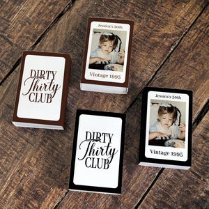 May include: Four matchbox-style containers with custom designs. Two boxes feature the text "DIRTY Thirty CLUB" in a script font. The other two boxes have a vintage photo and the text "Jessica's 30th" and "Vintage 1995".