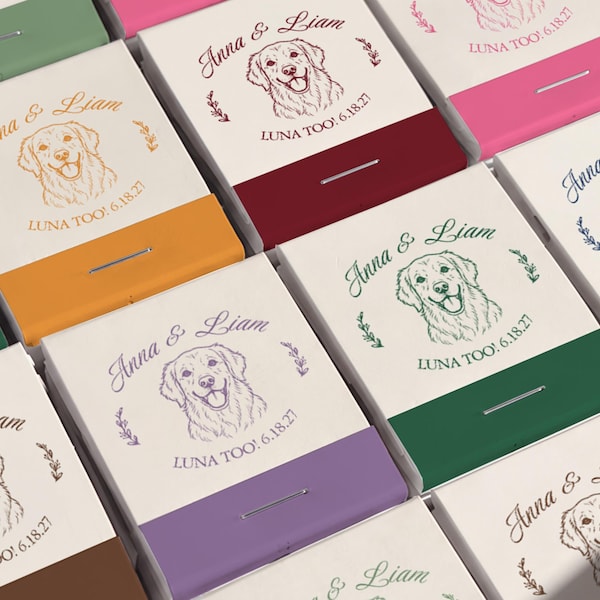 May include: A collection of rectangular matchboxes featuring a cream-colored top with a line drawing of a dog, the names Anna & Liam, and the text LUNA TOO! 6.18.27. Each box has a solid-colored base in shades of orange, red, green, purple, and blue.