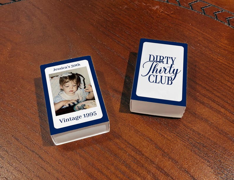 May include: Two navy blue and white matchbox-style boxes. One box has a photo of a young child with the text "Jessica's 30th" and "Vintage 1995". The other box has the text "Dirty Thirty Club" in a script font.
