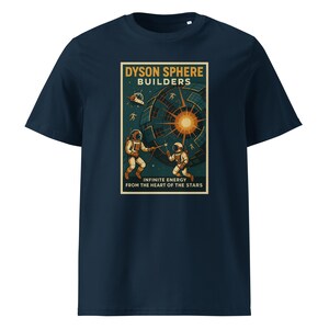May include: A navy blue t-shirt featuring a graphic print of two astronauts working on a Dyson sphere. The text reads DYSON SPHERE BUILDERS and INFINITE ENERGY FROM THE HEART OF THE STARS. The design includes a bright central star and space elements.