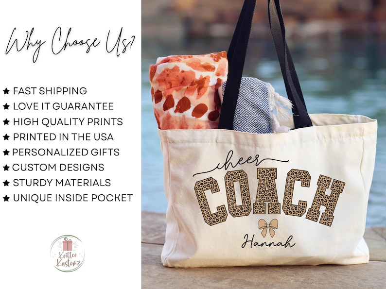 May include: A cream-colored tote bag with black handles, featuring the words "cheer COACH" in a leopard print design, with the name "Hannah" below. The bag contains a patterned blanket and towel.