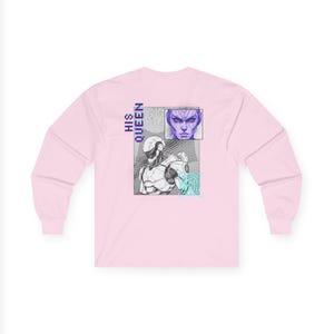 May include: A light pink long-sleeve shirt featuring a graphic design on the back. The design includes a robot, a human face, and the words "HIS QUEEN" in vertical text. The robot is in black and white, and the face is purple.