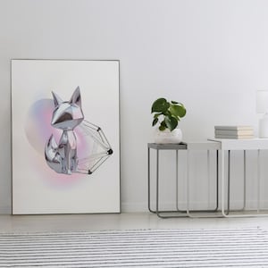 May include: A framed art print depicting a geometric silver fox and a geometric shape against a soft, colourful background. The artwork is displayed in a modern interior setting, alongside side tables, a lamp, and a potted plant.