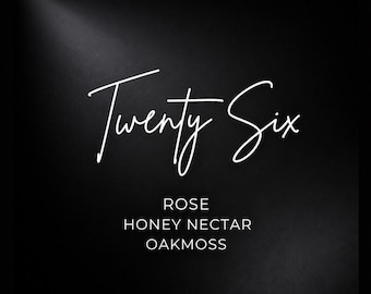 May include: A black square graphic featuring the white handwritten-style text Twenty Six centered at the top. Below the main text, the words ROSE, HONEY NECTAR, and OAKMOSS are printed in a clean, white, sans-serif font against the dark background.