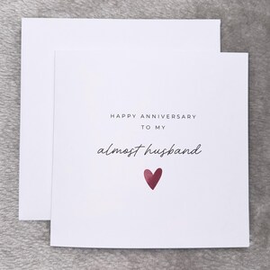 Minimalist greeting card printed on white 300gsm cardstock with text saying 'Happy Valentine's Day to My Almost Husband/Wife'. Simple romantic design with multiple variations, with white envelope.