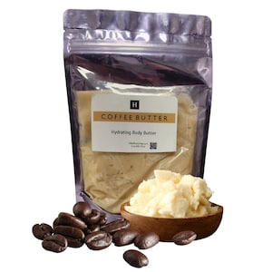 May include: A clear, resealable pouch containing light beige coffee butter with a white label reading COFFEE BUTTER Hydrating Body Butter. A small wooden bowl filled with the same butter sits next to several dark roasted coffee beans.