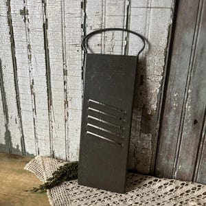 May include: A handmade, wooden cutting board with a natural finish. The board features a live edge on one side and a smooth, rectangular shape. It measures approximately 18 inches long and 12 inches wide.