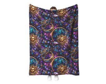 May include: A celestial-themed blanket featuring a repeating pattern of golden suns, crescent moons, and stars against a backdrop of purple, teal, and blue hues. The design has a stained-glass effect, creating a mystical and decorative look.