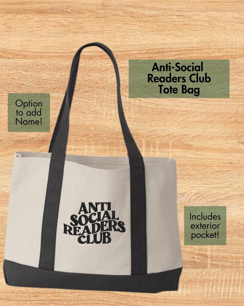 May include: Cream-colored tote bag with black handles and base. The words "ANTI SOCIAL READERS CLUB" are printed in black on the front. The bag has an exterior pocket and the option to add a name.