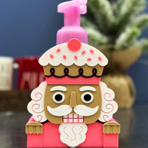 May include: A set of three ceramic mugs with a speckled, matte finish. The mugs are in shades of cream, light gray, and dark gray. Each mug has a simple, minimalist design, perfect for coffee or tea.