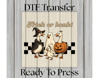 May include: DTF Transfer design featuring a Halloween theme. The image shows a group of geese dressed in Halloween costumes, including a witch, a ghost, and a jack-o'-lantern. The text "Trick or honk!" is displayed above the geese, and "Ready To Press" is below.