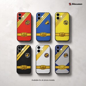 May include: Six phone cases featuring diagonal stripes, a central animal emblem, and a gold-colored belt buckle graphic. Colors include red, blue, yellow, black, white, and gray. The text Shincustom and Avaliable for all phone models are visible.