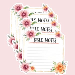 May include: A stack of floral-themed Bible Notes stickers. Each sticker features the words "Bible Notes" in black, with lined space for writing. The stickers are decorated with pink and orange flowers and green leaves, set against a light pink background.