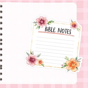 May include: A floral sticker with the text "BIBLE NOTES" on a lined notepad. The sticker features pink and orange flowers with green leaves. The notepad is on a pink and white checkered background.