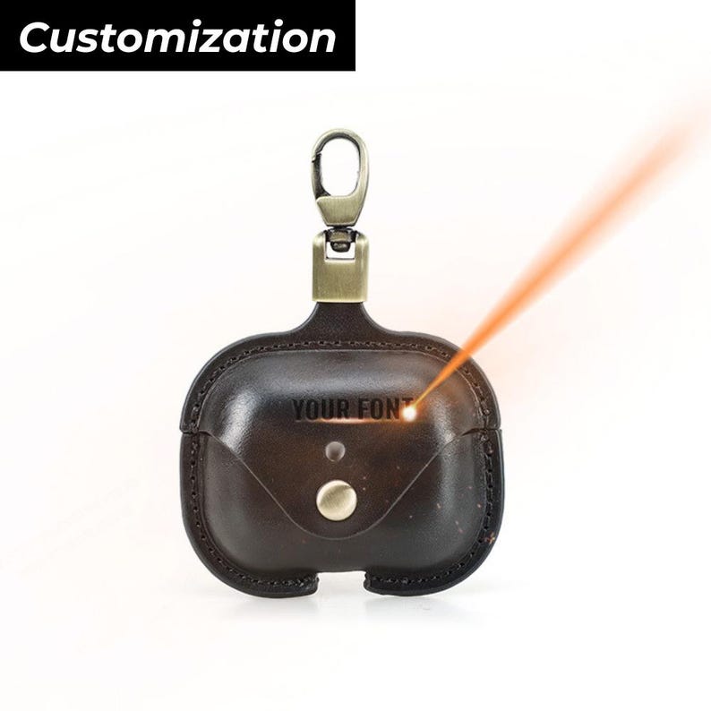 May include: A dark brown leather AirPod case with a metal clasp and button closure. The case has the text "YOUR FONT" engraved on the front. The word "Customization" is in a black box at the top.