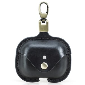 May include: Black leather AirPod case with a metal clasp and button closure. The case has a stitched border and a small flap. The metal hardware has a bronze finish.