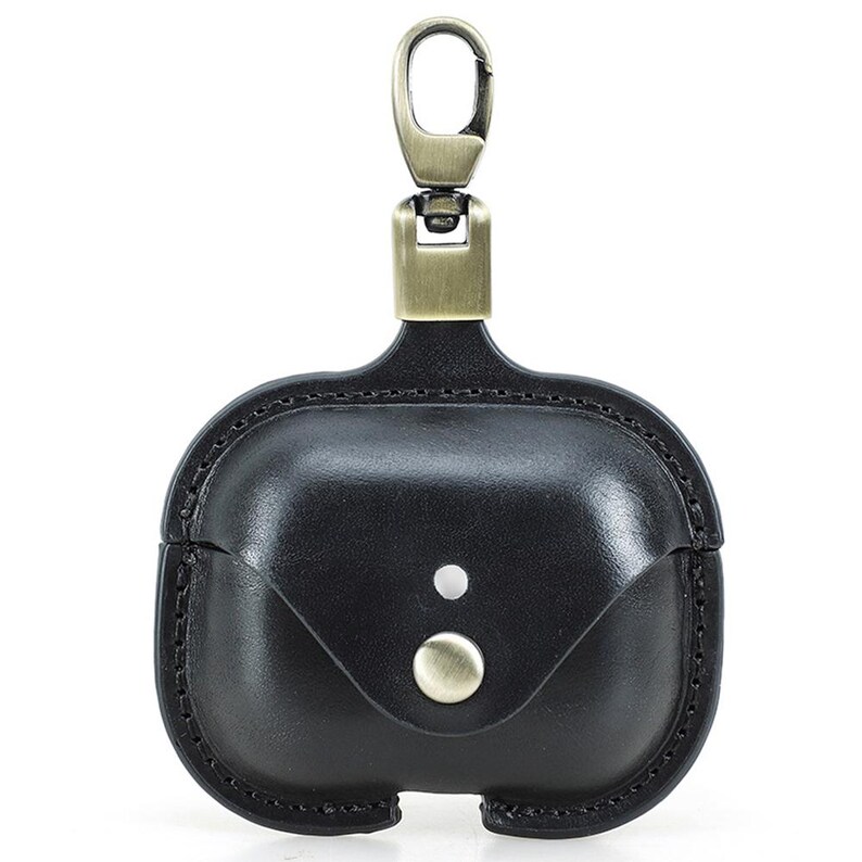 May include: Black leather AirPod case with a metal clasp and button closure. The case has a stitched border and a small flap. The metal hardware has a bronze finish.