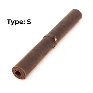 May include: Rolled-up brown leather mat with a strap and snap closure. The text "Type: S" is printed in black on the upper left. The mat is made of a distressed leather material.