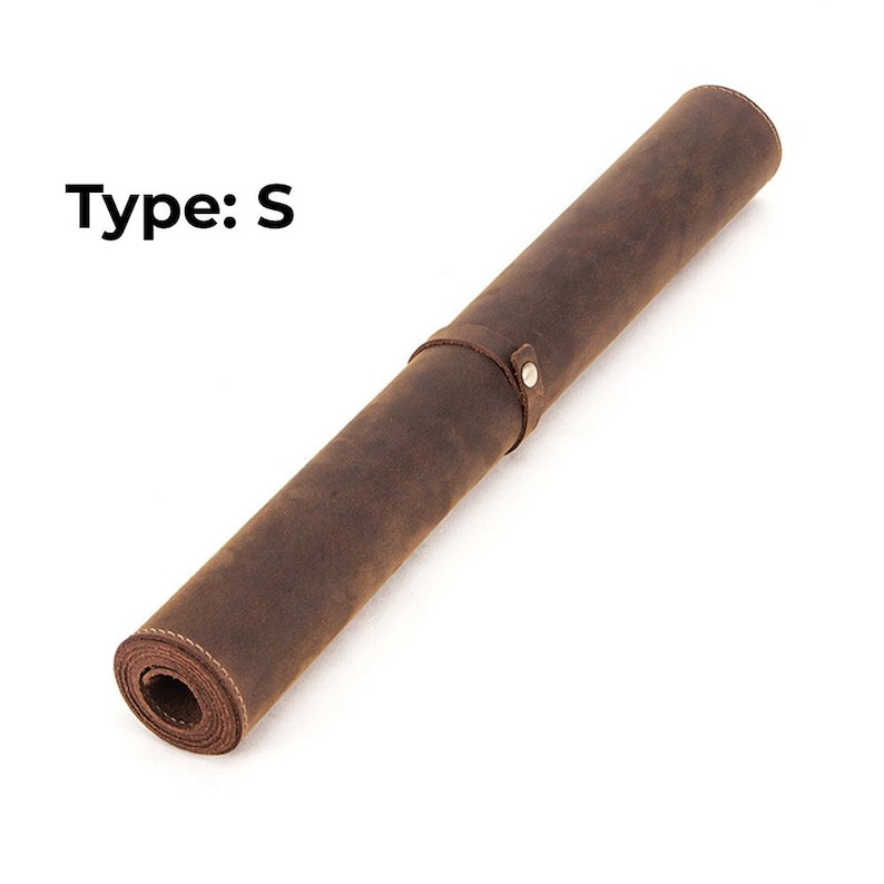 May include: Rolled-up brown leather mat with a strap and snap closure. The text "Type: S" is printed in black on the upper left. The mat is made of a distressed leather material.