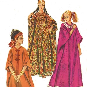 May include: Three women wearing long, flowing robes. The woman on the left is wearing an orange robe with a gold trim. The woman in the center is wearing a patterned robe with gold and brown colors. The woman on the right is wearing a pink robe with white trim.