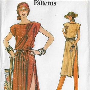 May include: A vintage sewing pattern for a long, loose-fitting dress with a tie belt and side slits. The dress is shown in two versions: one with a brown and white polka dot print and the other in a solid beige color.