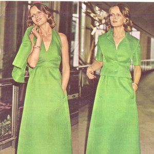 May include: Two women wearing green dresses. The dress on the left is a sleeveless maxi dress with a V-neck. The dress on the right is a short-sleeved dress with a collar and a button-up front. Both dresses are a vibrant green colour.