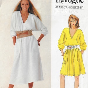 May include: A sewing pattern for two dresses. The first dress is white with a brown belt and the second dress is yellow with a brown belt. The pattern is by American designer Barbara Evans.