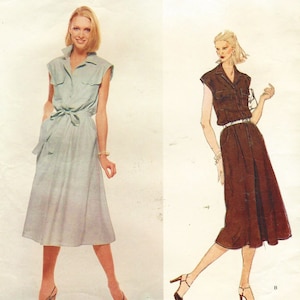 May include: Two women's dresses, one light blue and one brown, with a button-up front, short sleeves, and a belt. The dresses are knee-length and have a relaxed fit.
