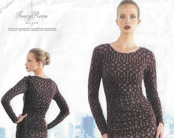 May include: A long-sleeved dress with a geometric pattern in shades of brown and gray. The dress has a fitted silhouette and a round neckline. The dress is shown on a model with a city skyline in the background.