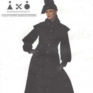 May include: A black long-sleeved coat with a button-up front and a wide collar. The coat has a fitted waist and a flared skirt. The model is wearing black gloves and a black hat with a brim.
