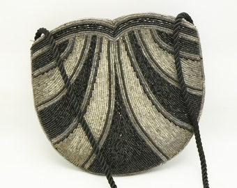 May include: A black and silver beaded evening bag with a black rope strap.