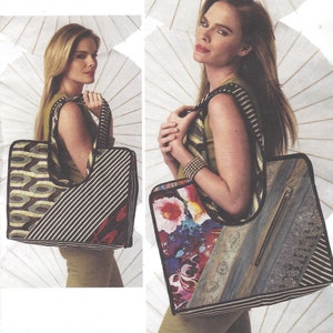 Puede incluir: Un bolso tote grande de rayas blancas y negras con un diseño de patchwork. El bolso tiene una cremallera y una parte superior grande y abierta. El bolso está hecho de diferentes telas, incluyendo un estampado floral, un estampado geométrico y una tela rayada.